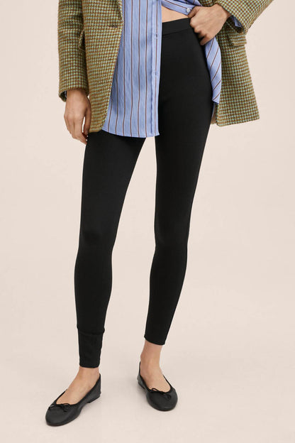 Black slim-fit pants with tapered legs and ankle length