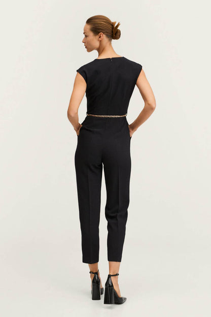 Black sleeveless V-neck jumpsuit with chain belt, back view