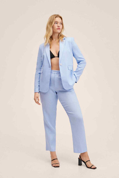Sky-blue blazer and trousers set with flap pockets, styled with black sandals