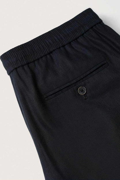 Dark navy elastic waistband trousers with metal button and seams