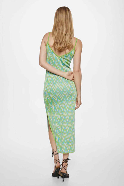 Back view of green chevron knit midi slip dress with thin straps and side slit