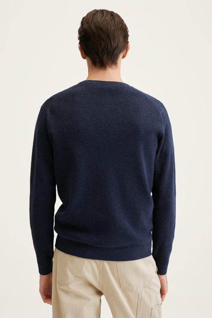Navy crewneck sweater, back view, long sleeves with ribbed cuffs
