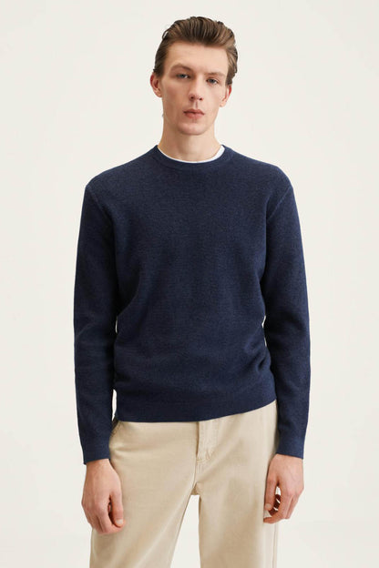 Navy crewneck sweater with long sleeves and ribbed cuffs and hem
