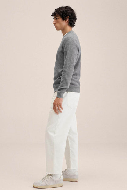 Men's heather grey crewneck sweater, side view with long sleeves and ribbed cuffs
