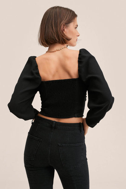 Black ruched corset-style crop top with puff sleeves, sweetheart front and square back