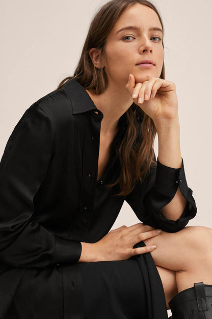 Black button-front midi dress close-up: collar and buttons, long sleeves