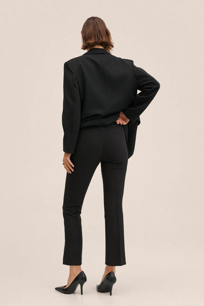 Black blazer and slim straight-leg trousers, back view