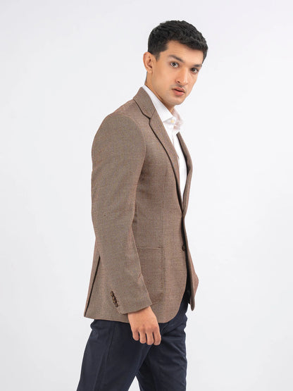 Men's brown blazer with textured fabric, notch lapels, and front button closure