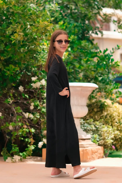 Black long-sleeve maxi dress with round neck, front view with sunglasses