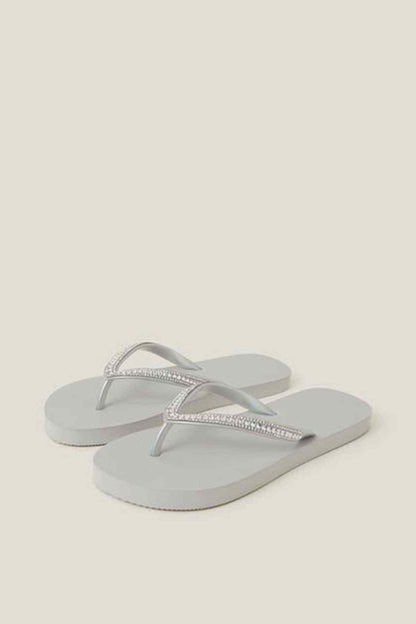 Silver rhinestone toe-thong flip-flops, pair on display