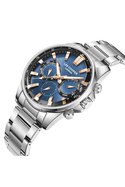 Silver watch close-up with blue multi-dial face, gold markers, and crown