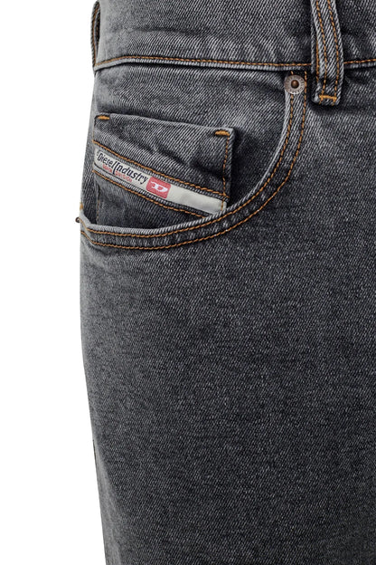 Diesel dark wash jeans close-up: coin pocket, stitched seams, leather logo patch