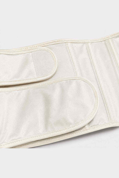 Cream belly band close-up with curved pocket seam and vertical stitching