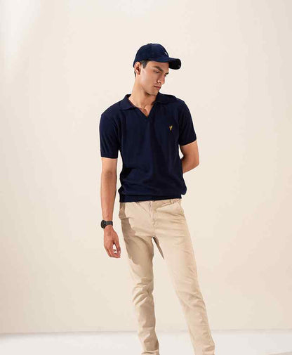 Navy fitted baseball cap with small logo, worn on model.