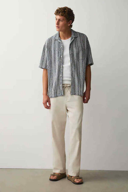 Men's striped short-sleeve shirt and cream drawstring trousers