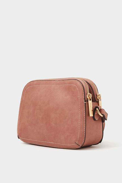 Dusty pink compact crossbody bag with double zip openings and gold-tone hardware