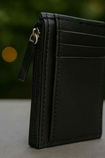 Black leather card holder side view with zipper pull and metal ring