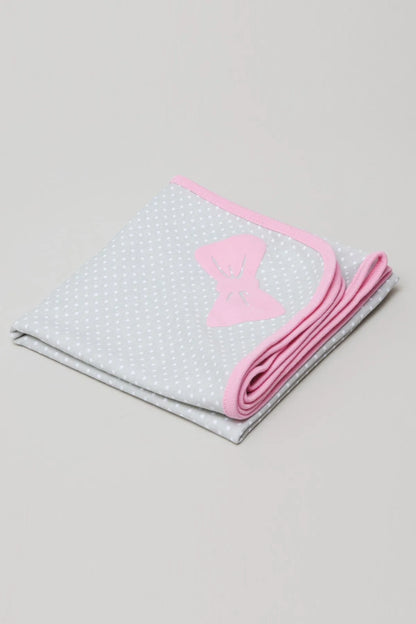 Baby blanket with white dotted fabric, pink trim, folded with bow applique