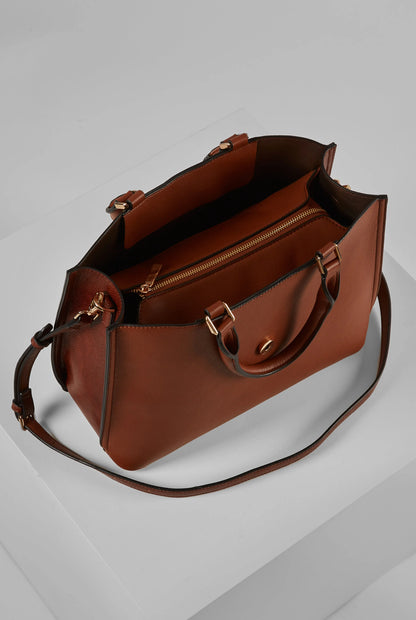 Brown leather tote bag with side zipper, shoulder strap, and metal hardware
