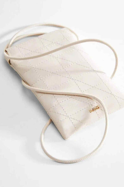 Off-white quilted mini crossbody bag with adjustable shoulder strap and front logo