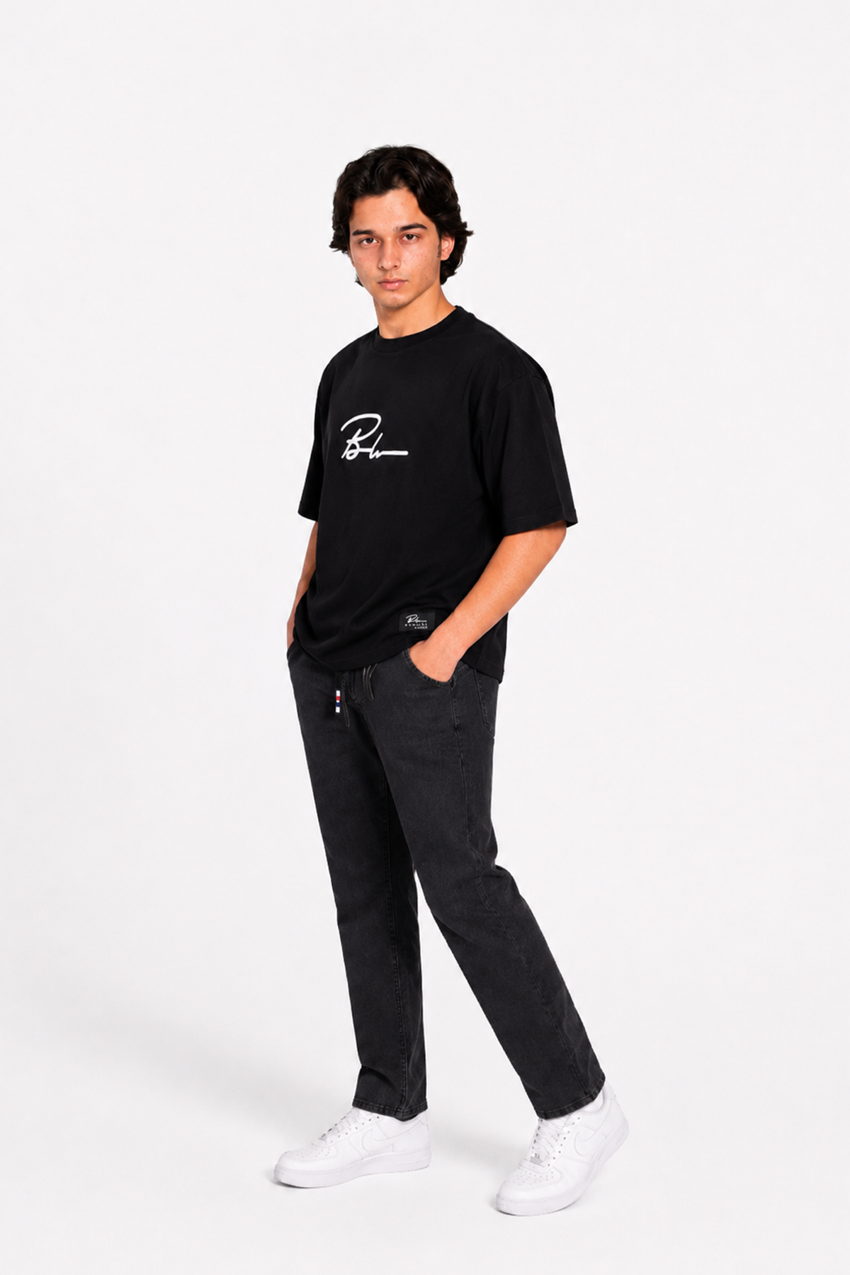 Jet black graphic T-shirt with black jogger pants and white sneakers