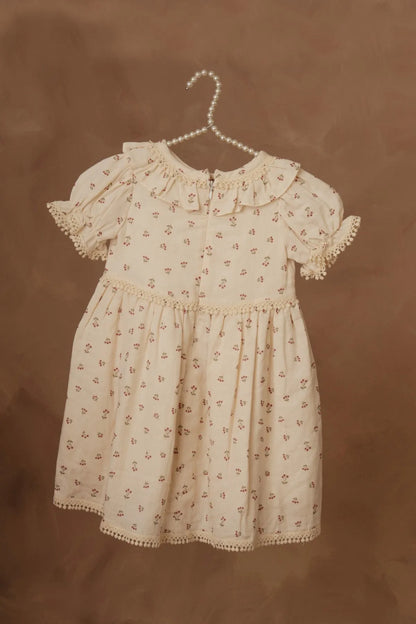 Cream floral short-sleeve dress with puff sleeves, gathered waist, and scalloped hem