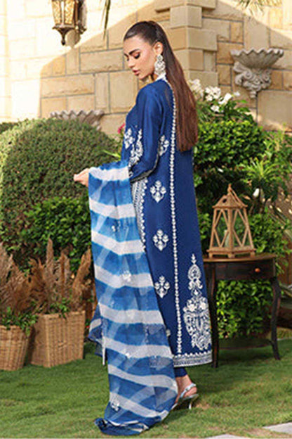 Blue embroidered long dress with check dupatta trailing, side view