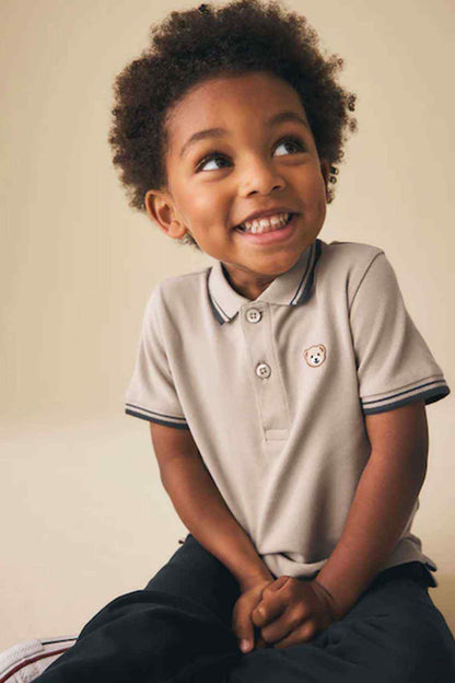 Kids stone polo shirt with navy striped cuffs and bear emblem on chest