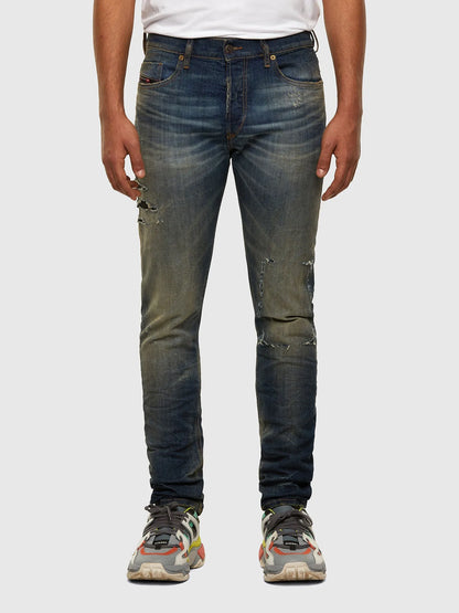 Blue Diesel jeans with distressed knees and straight slim legs