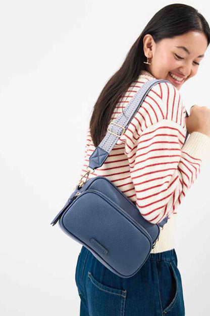 Blue crossbody bag with zip top and adjustable strap, gold hardware