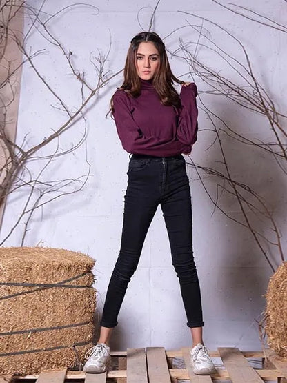Burgundy turtleneck long-sleeve top with fitted dark jeans and sneakers, front standing pose