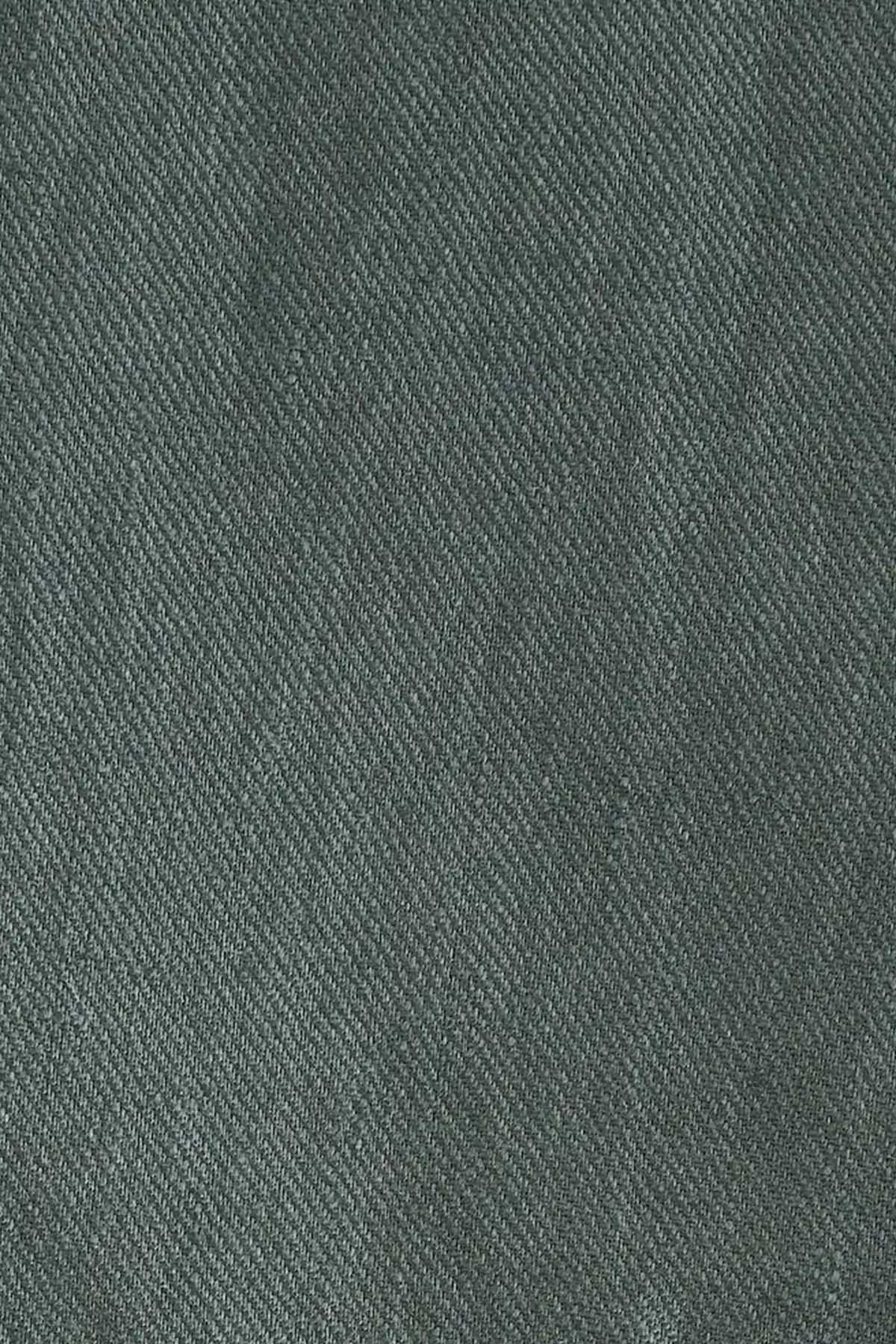 Green woven suit fabric texture close-up
