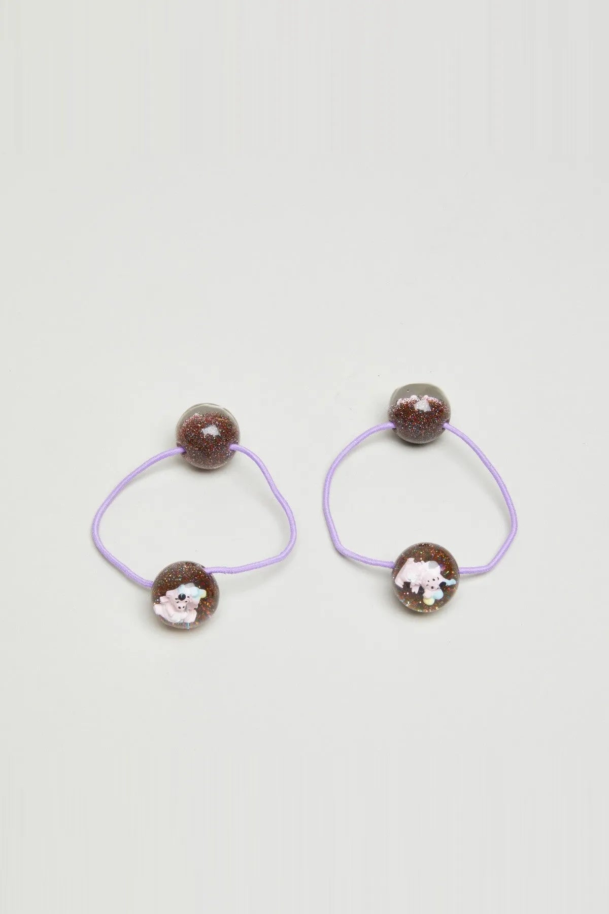 Two kids hair elastics with lilac elastic loops and glitter brown bead charms