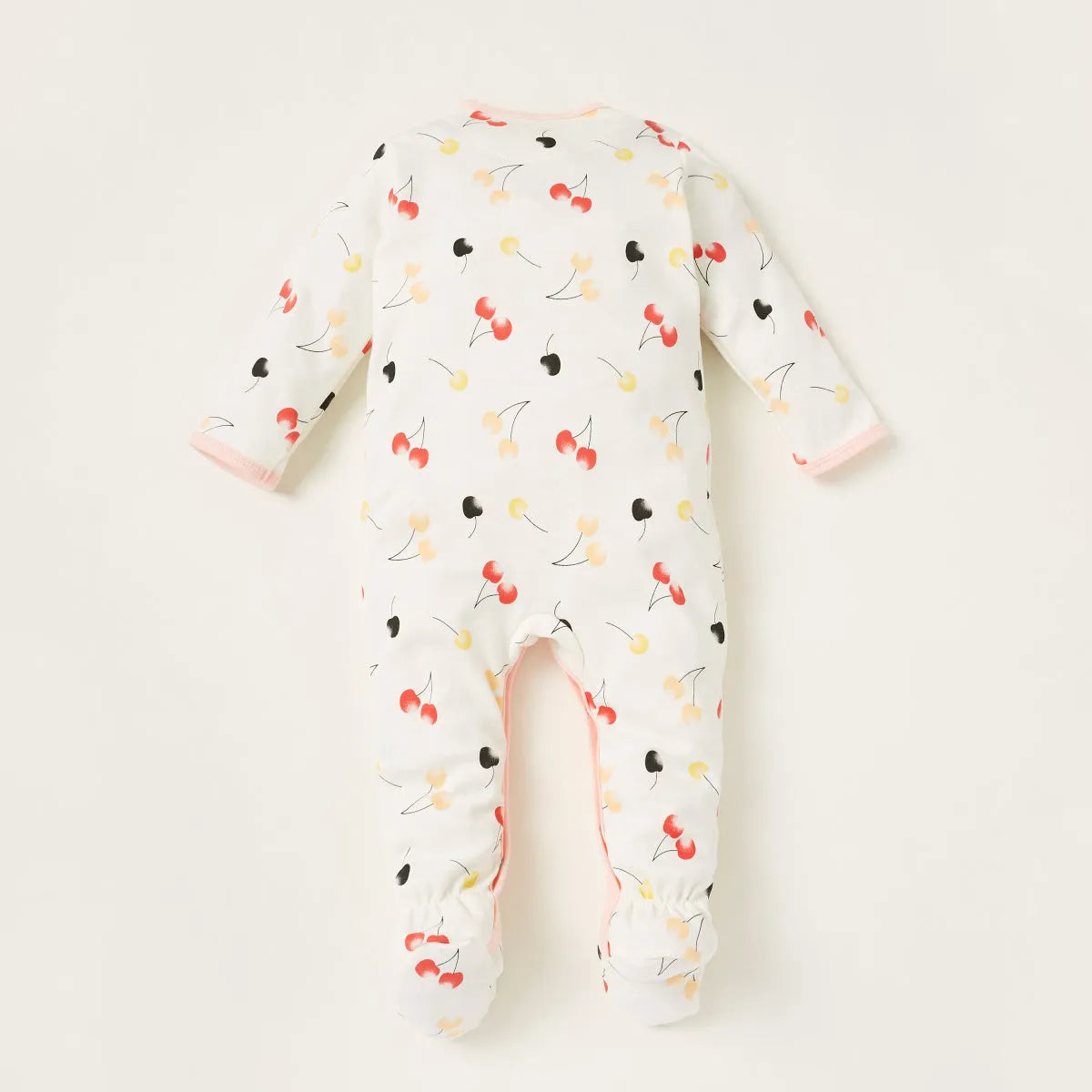 White baby footie sleeper with multicolor fruit print, long sleeves, open feet