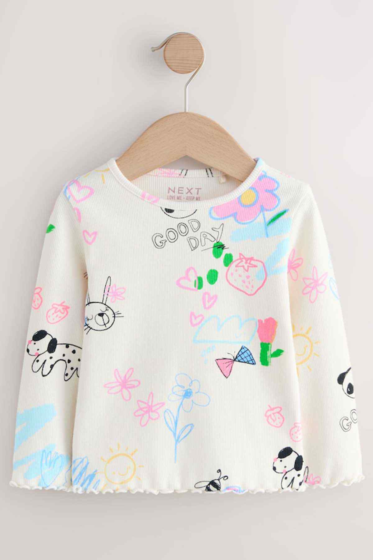 Kids ecru long-sleeve graphic top hanging on wooden hanger, NEXT label