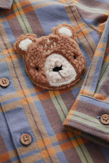 NEXT kids plaid shirt close-up: bear face applique and wooden-look buttons