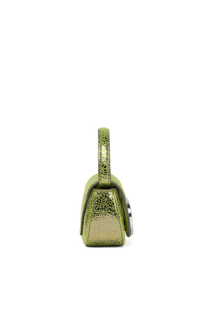 Green textured mini handbag, side profile with top handle and clasp.