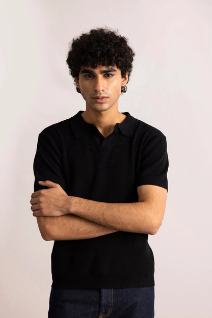 Men's black polo shirt with short sleeves and collar, folded-arm front