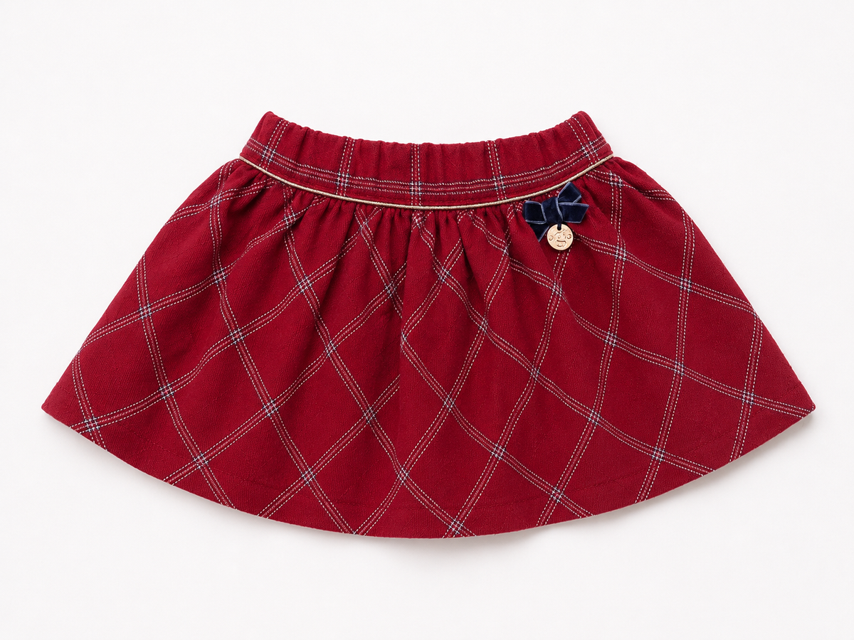 Red plaid baby skirt with elastic waistband and button detail