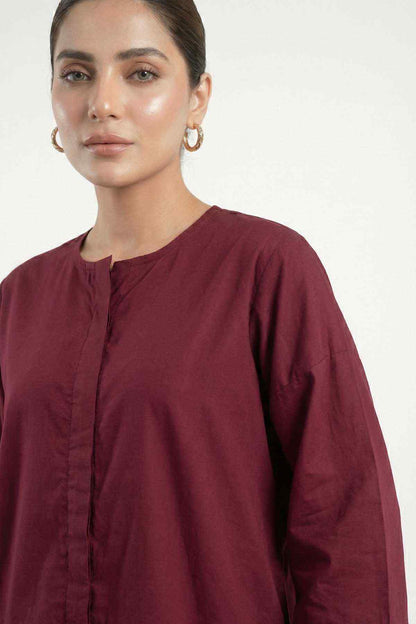 Dark maroon tunic close-up with button placket and textured center-front stitching