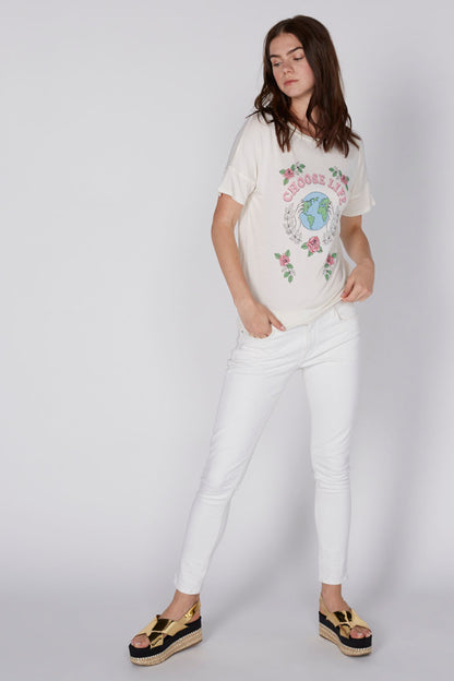 White women's graphic T-shirt with colorful globe and floral print, side view