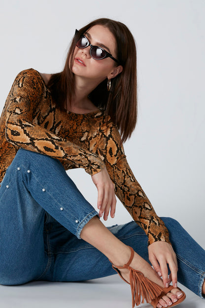 Blue distressed straight-leg jeans with pearl button side detail and frayed rips