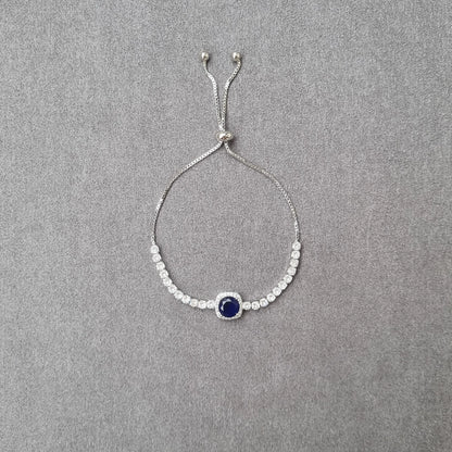 Adjustable beaded bracelet with central blue round crystal and link stones