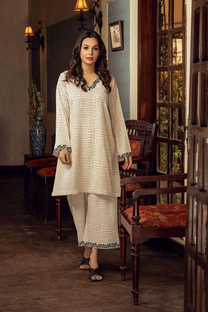 Off-white long tunic and pajama set with dark patterned trim at cuffs and hem