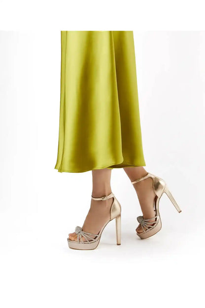 Dune London gold heeled platform sandals with ankle strap and bow lace closure