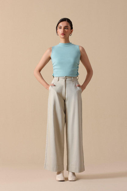Mint sleeveless crop top with light beige wide-leg trousers, front view