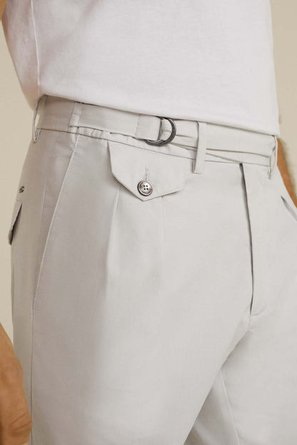 Beige trousers waistband with belt loops, buttoned flap pocket, and zip fly