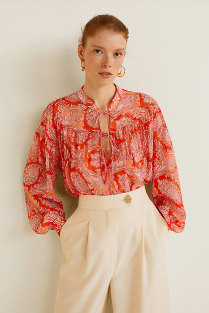 Orange printed blouse with tie-neck, long puff sleeves
