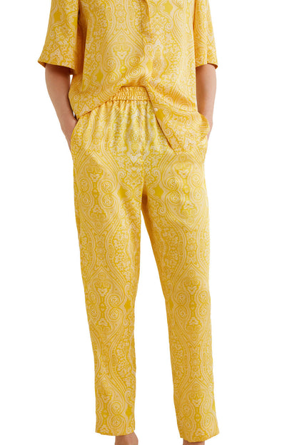 Yellow patterned pants with elastic waist and tapered ankle-length legs