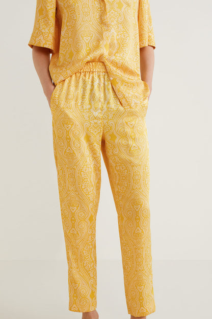 Yellow patterned pants with elastic waist and tapered legs